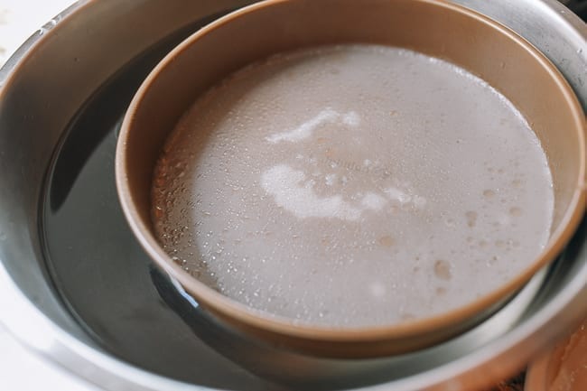 Noodle cooling on bowl of cold water, thewoksoflife.com