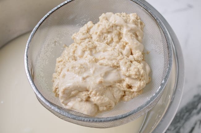 Pouring dough through fine-meshed strainer, thewoksoflife.com