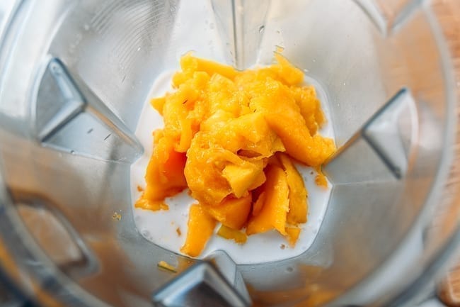 Blender with mango, condensed milk, coconut milk, thewoksoflife.com