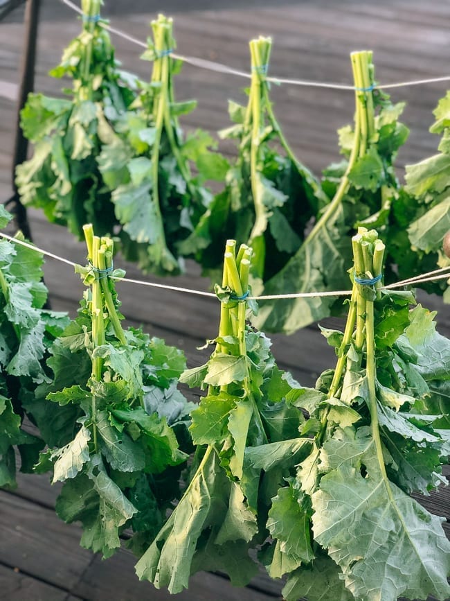Drying greens in bundles outside, thewoksoflife.com