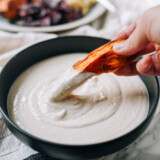 Dipping roasted sweet potato in tofu garlic aioli, thewoksoflife.com