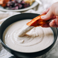 Dipping roasted sweet potato in tofu garlic aioli, thewoksoflife.com