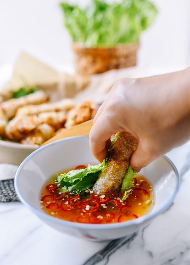 Dipping cha gio into nuoc cham, thewoksoflife.com