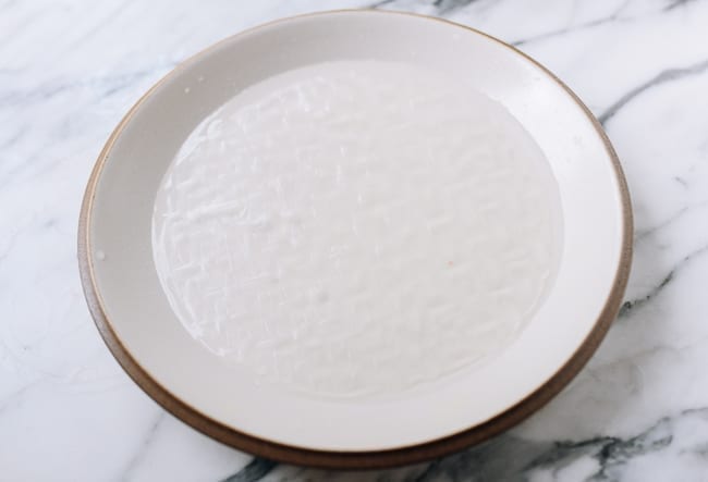 Soaking rice paper in sugar water, thewoksoflife.com