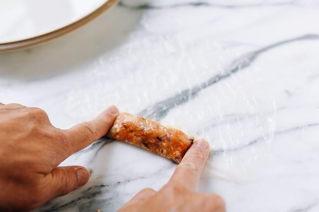 Pressing rice paper around filling, thewoksoflife.com