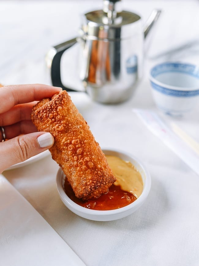 Dipping egg roll into duck sauce and hot mustard, thewoksoflife.com