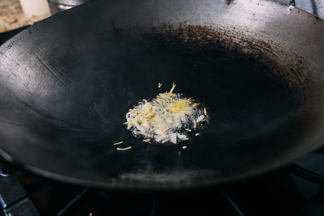 Oil, ginger, and garlic in wok