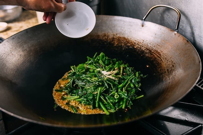 Seasoning vegetables with sugar, white pepper, and MSG