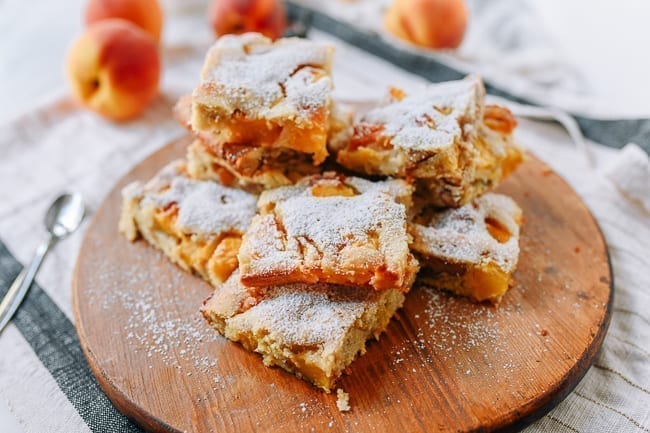 Pile of peach squares dusted with powdered sugar, thewoksoflife.com