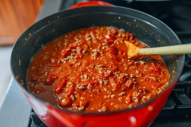 Stirring pot of tomato meat sauce, thewoksoflife.com