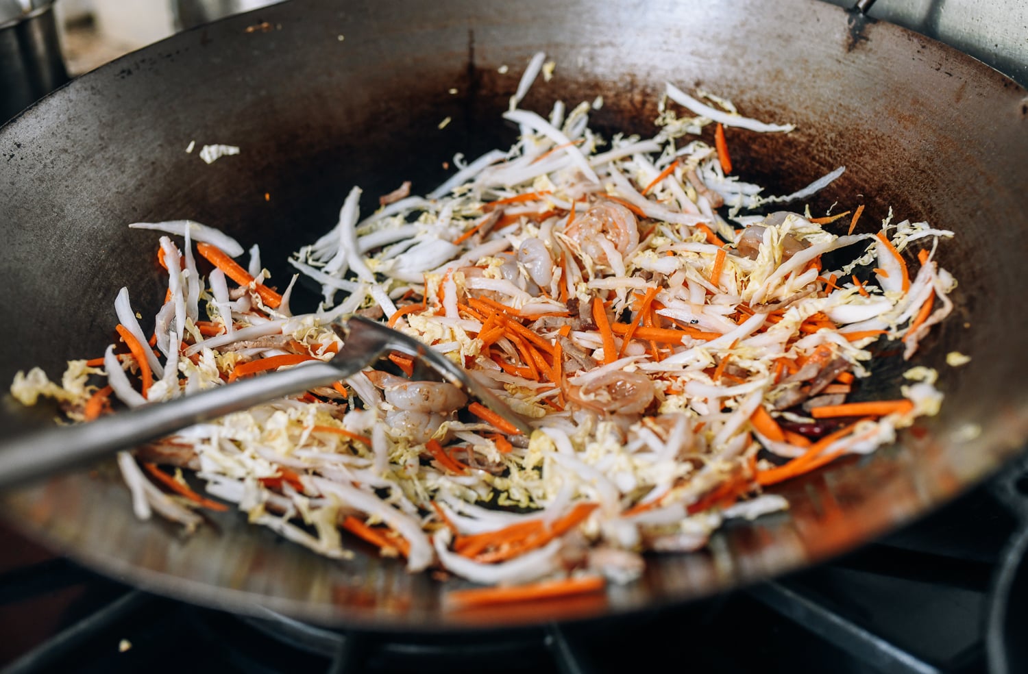 Stir-frying Singapore noodle ingredients, thewoksoflife.com