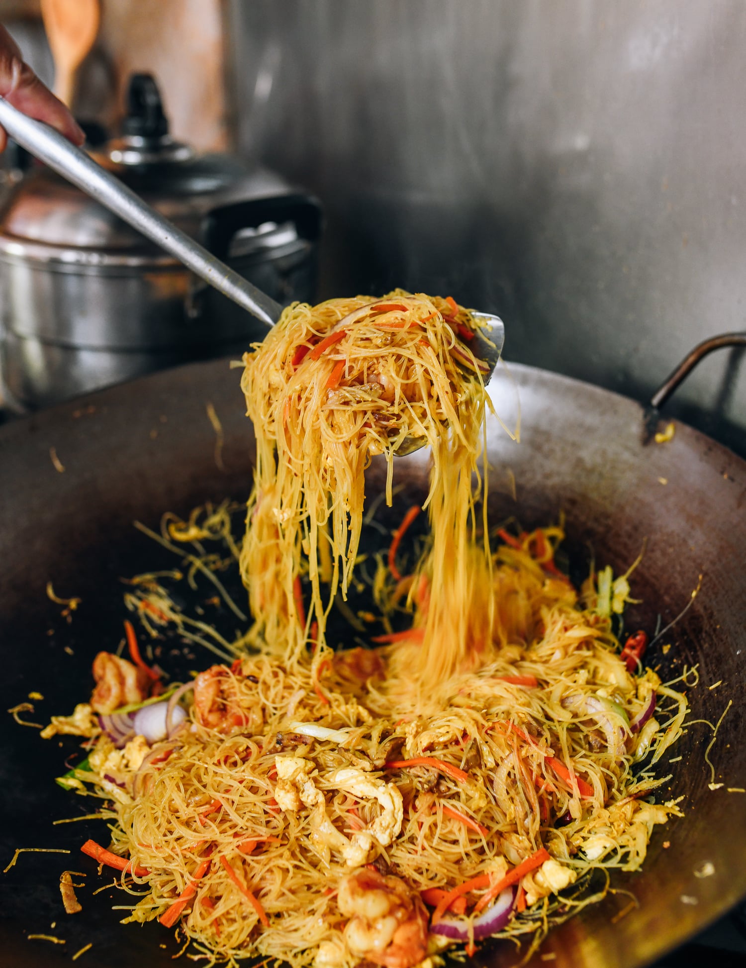 Stir-frying singapore mei fun, thewoksoflife.com