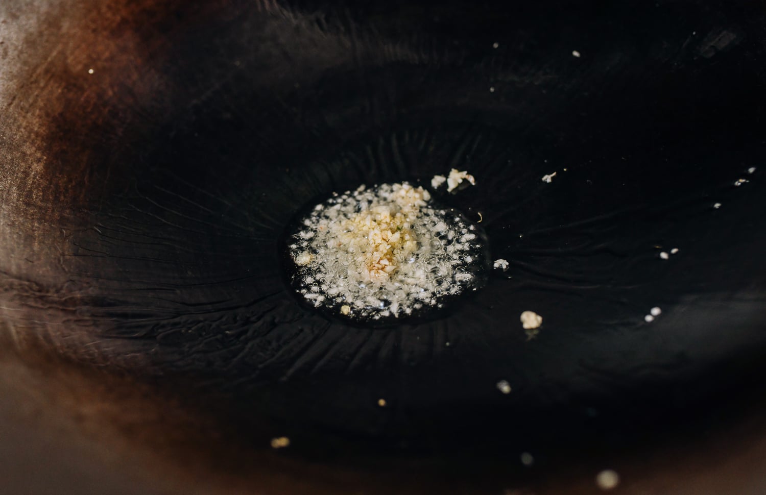 Oil and garlic in wok, thewoksoflife.com