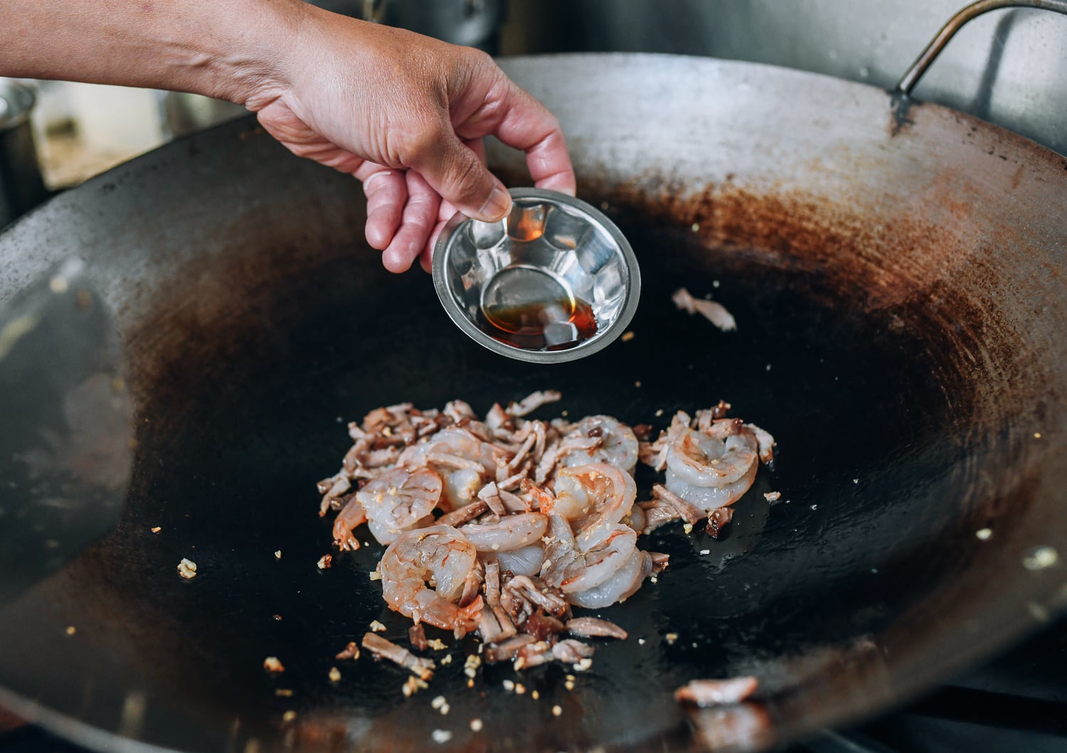 Adding Shaoxing wine to shrimp and pork, thewoksoflife.com
