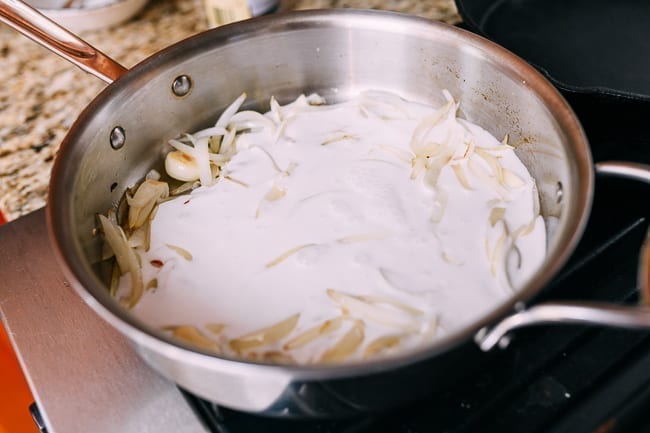 Adding coconut milk to onions, thewoksoflife.com