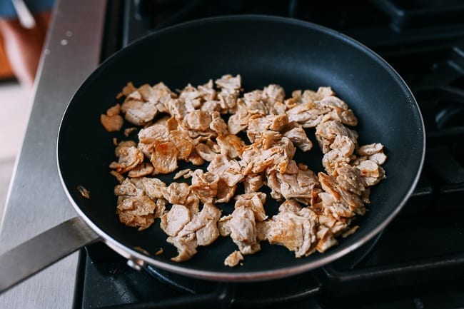 Browning pieces of seitan in nonstick pan, thewoksoflife.com