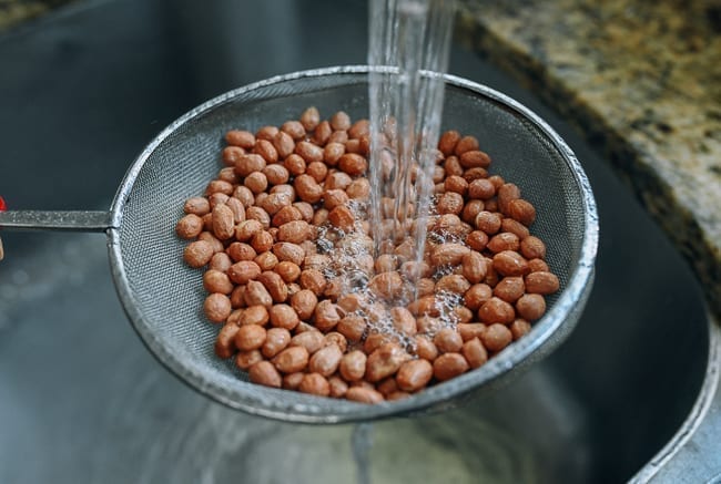 Rinsing peanuts under running water, thewoksoflife.com