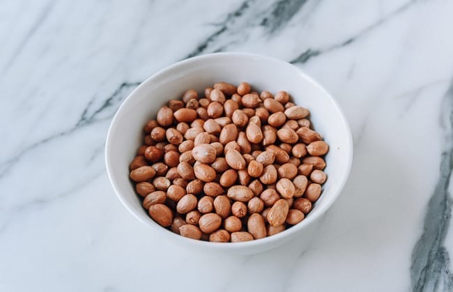Bowl of peanuts with skin still on, thewoksoflife.com