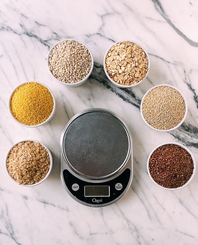 1 cup each of six different grains around digital scale, thewoksoflife.com
