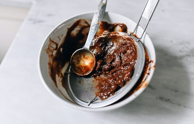 Pressed Tamarind pulp through strainer, thewoksoflife.com