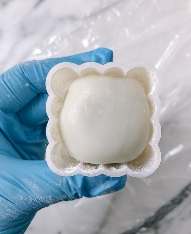 Snow skin mooncake dough and filling ball inside mold, thewoksoflife.com