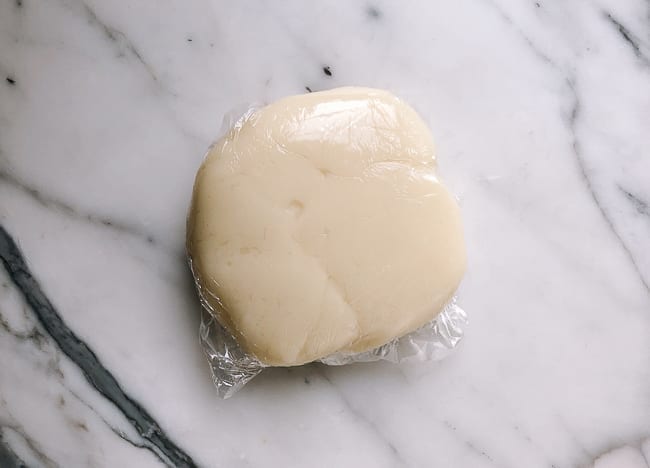 Snow skin mooncake dough disc wrapped in plastic, thewoksoflife.com