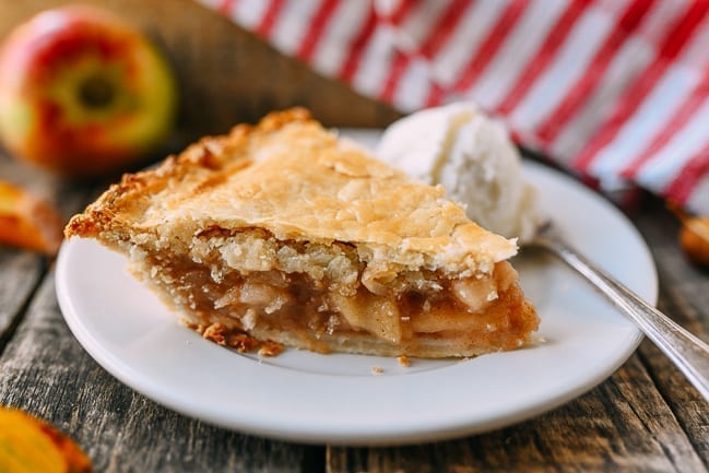 Slice of flaky apple pie with ice cream, thewoksoflife.com