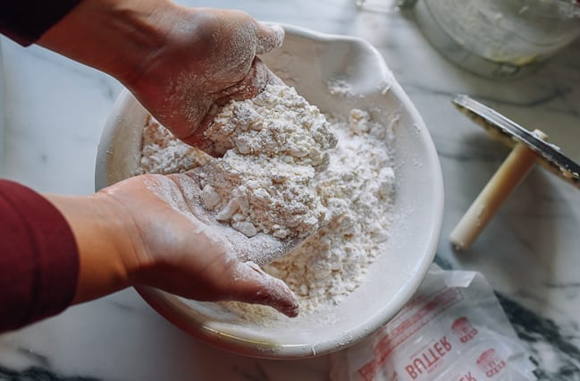 Combining flour and butter with hands, thewoksoflife.com