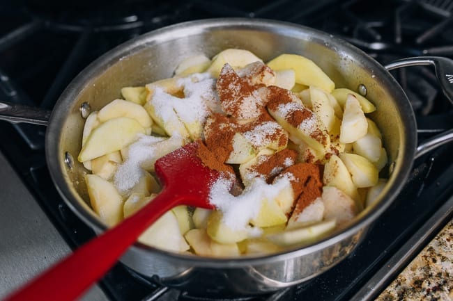 Adding cinnamon, sugar, and lemon juice to apples, thewoksoflife.com