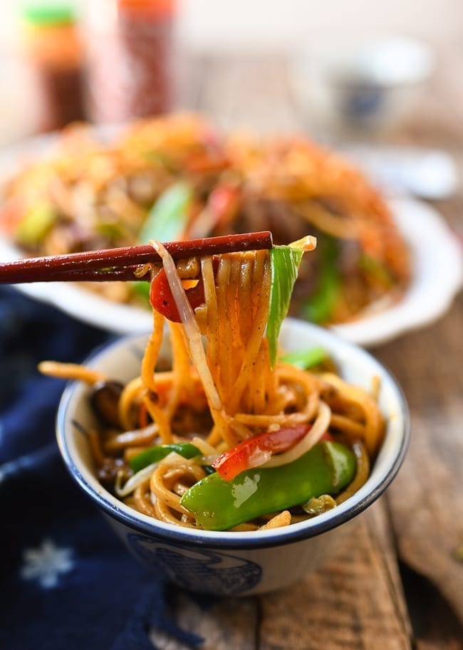 Lifting lo mein with chopsticks, thewoksoflife.com