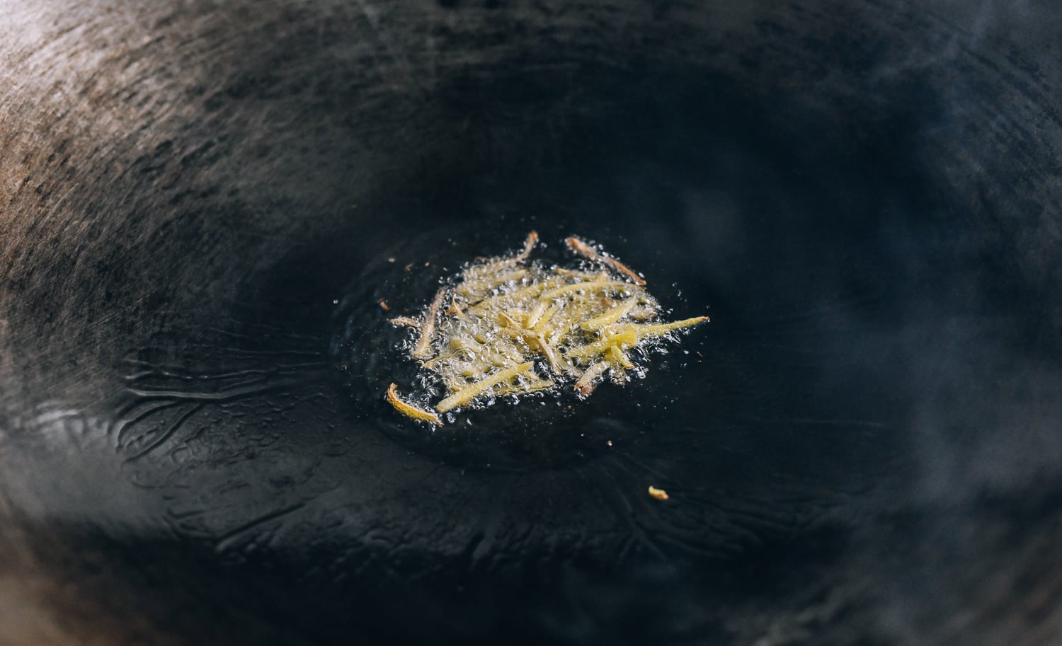Adding ginger to oil in wok, thewoksoflife.com