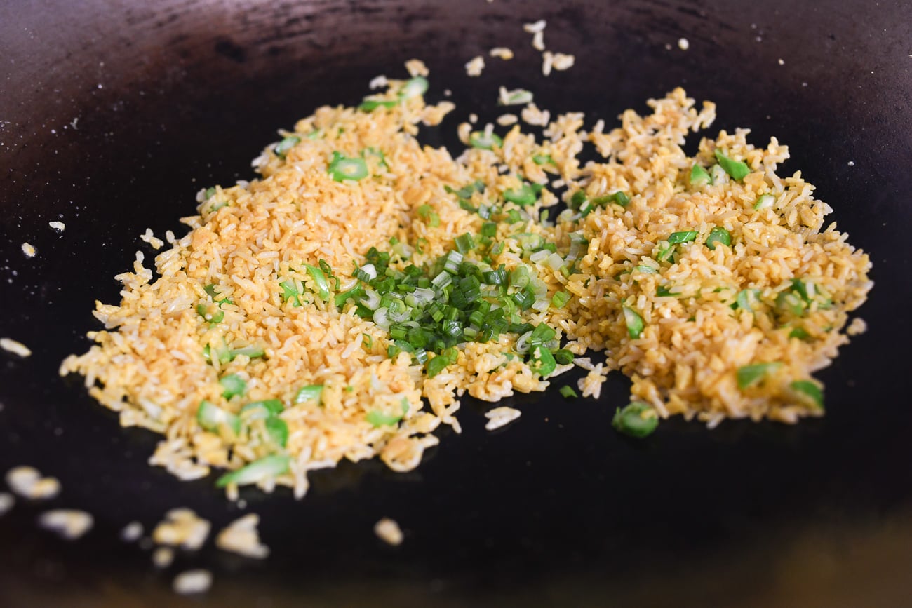 Adding scallions to fried rice