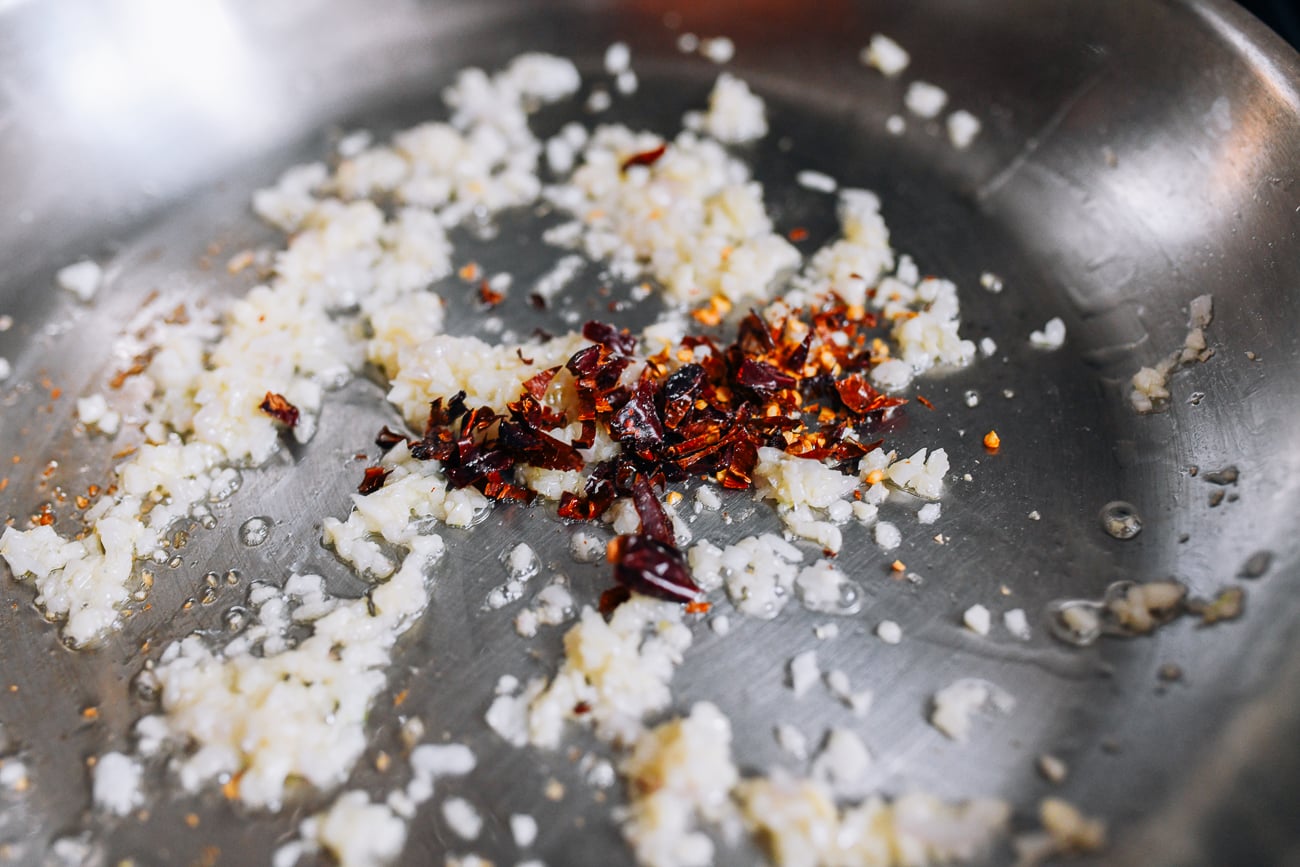 Shallots, garlic, and chili peppers in pan