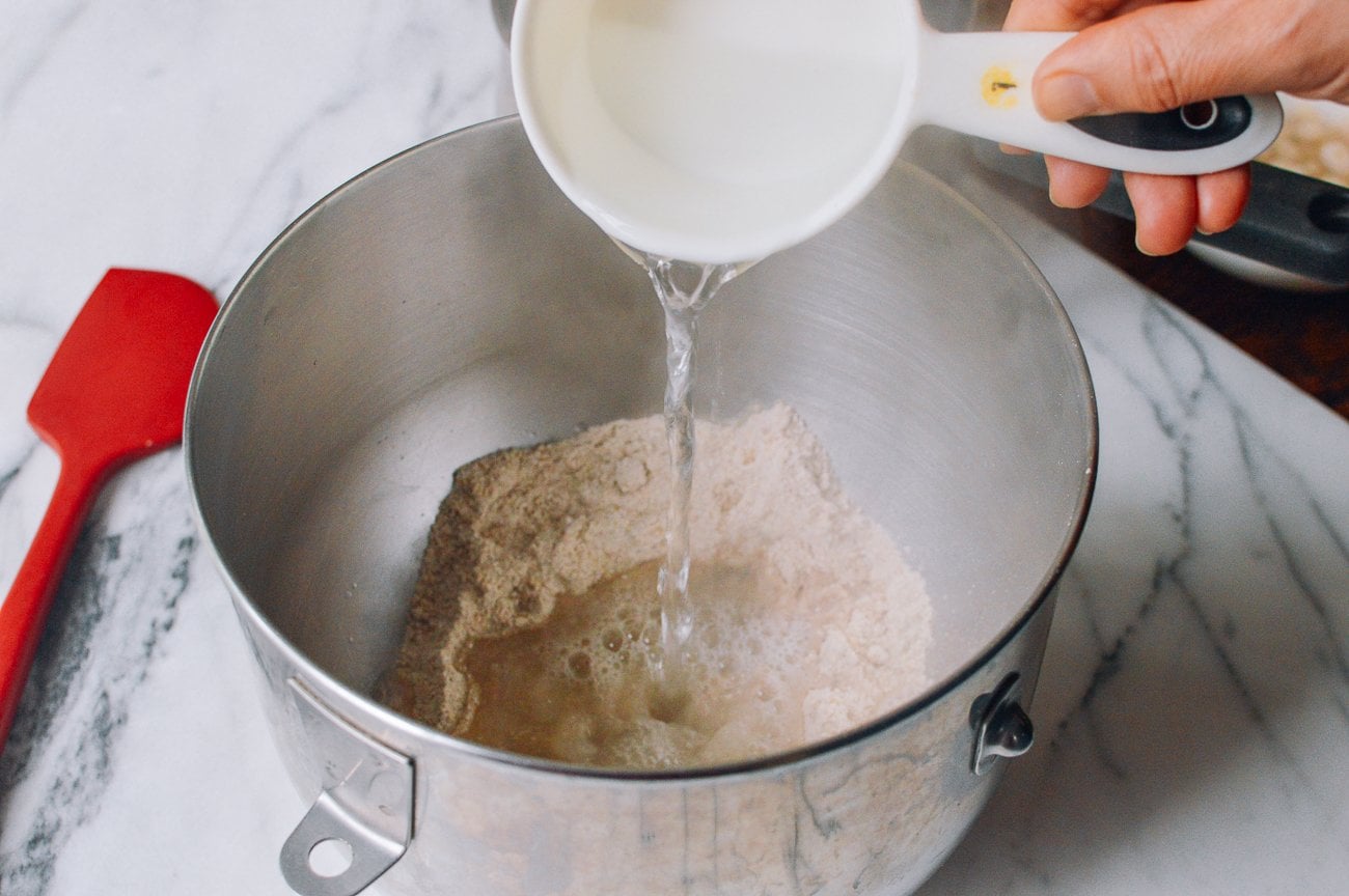 adding boiling water to multigrain cereal mix in stand mixer bowl