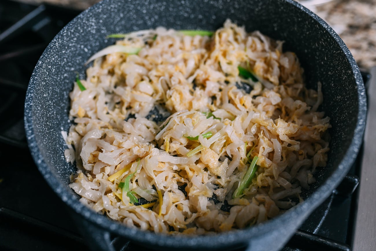 Stir-frying Chinese sour napa cabbage with scallions and ginger