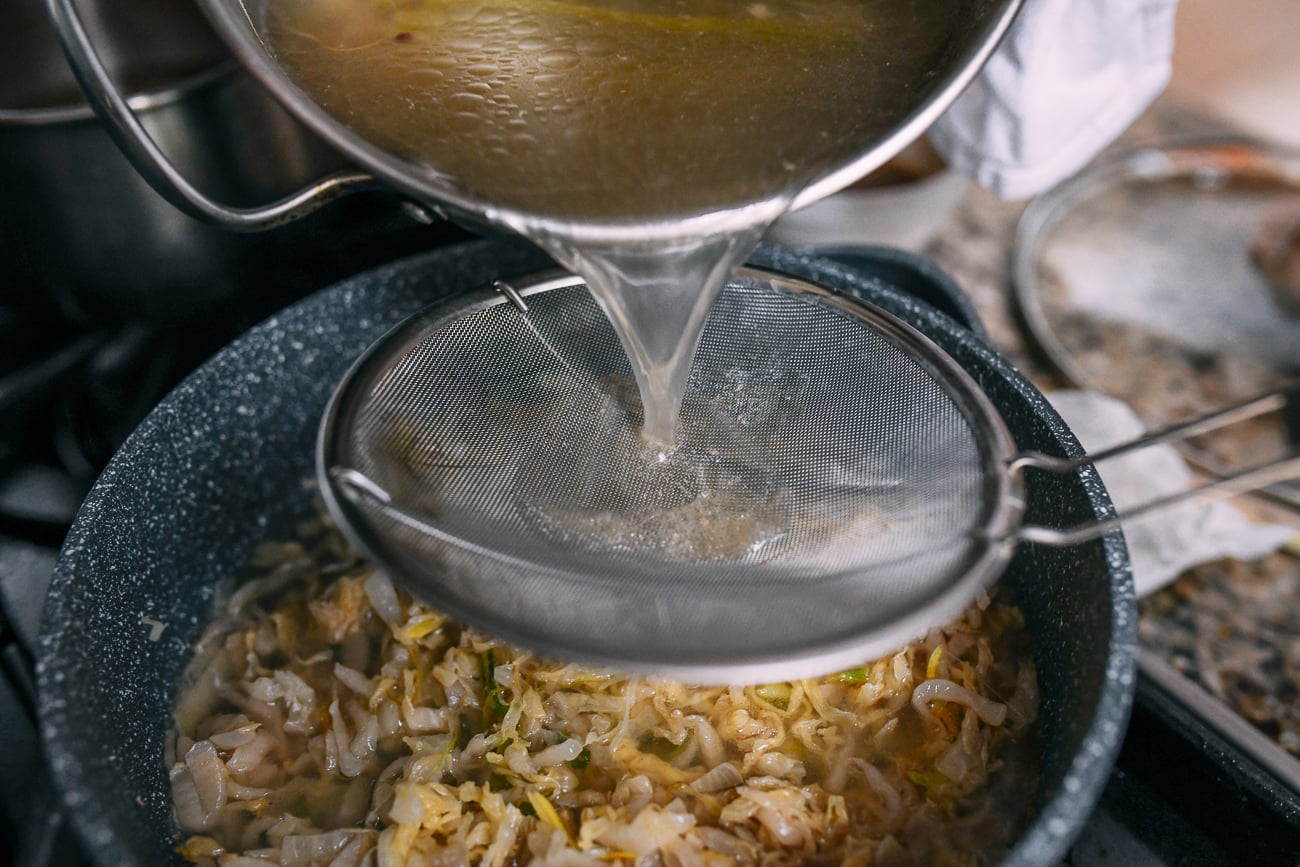 Strain pork stock into soup