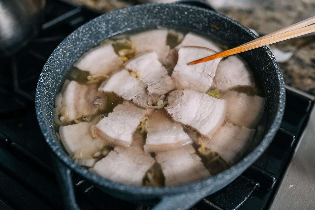 Adding pork belly to pot