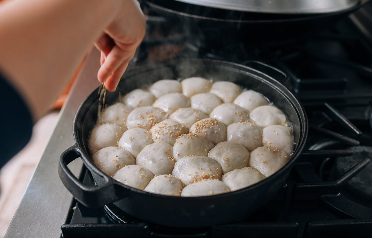 Sprinkling buns with sesame seeds, thewoksoflife.com