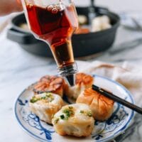 Pouring Shanghai rice vinegar over shengjian mantou, thewoksoflife.com