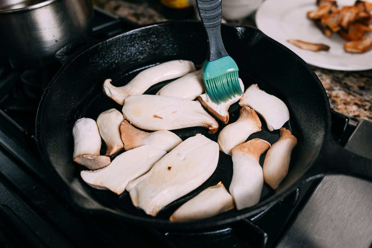Brushing oyster mushrooms with oil