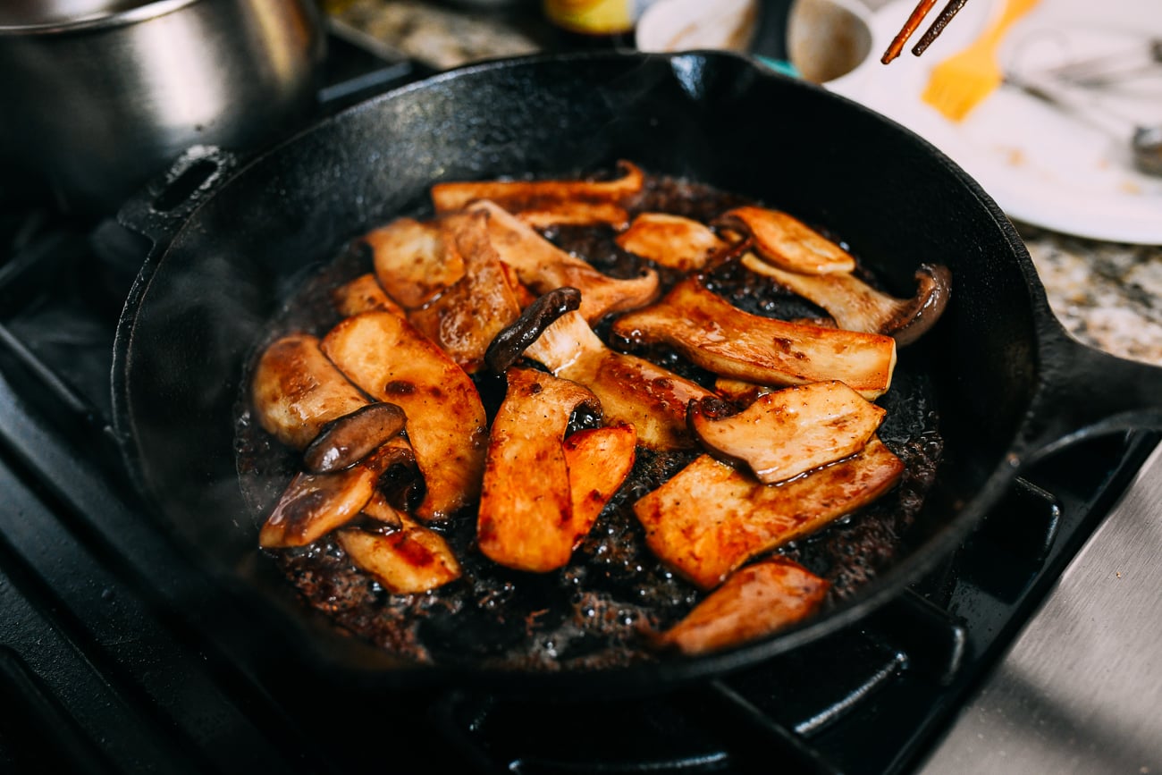 Tossing mushrooms in soy butter sauce