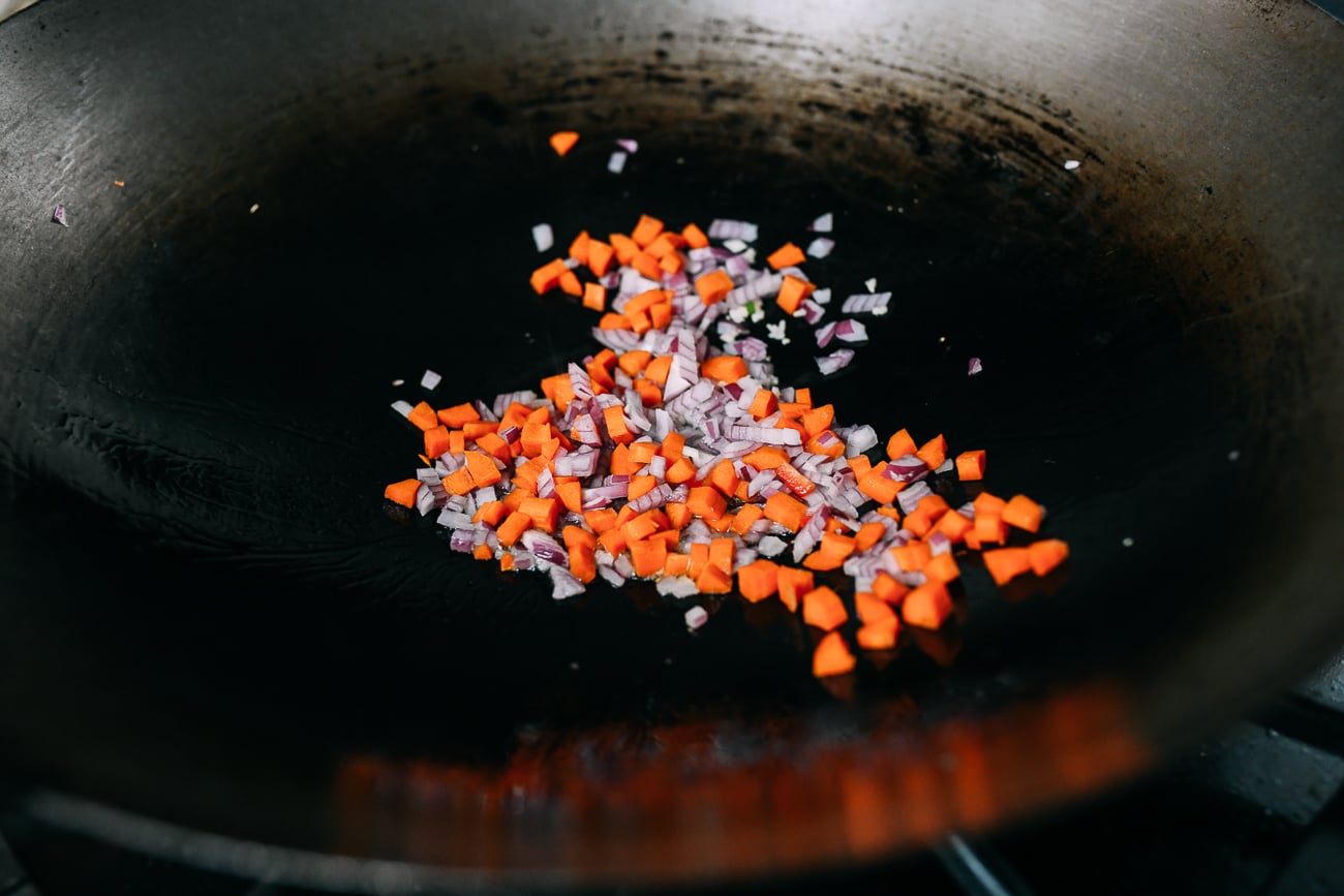 Onions, garlic and carrots in wok