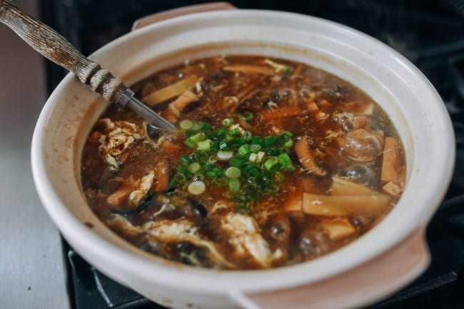 Adding scallion to vegetarian hot and sour soup, thewoksoflife.com