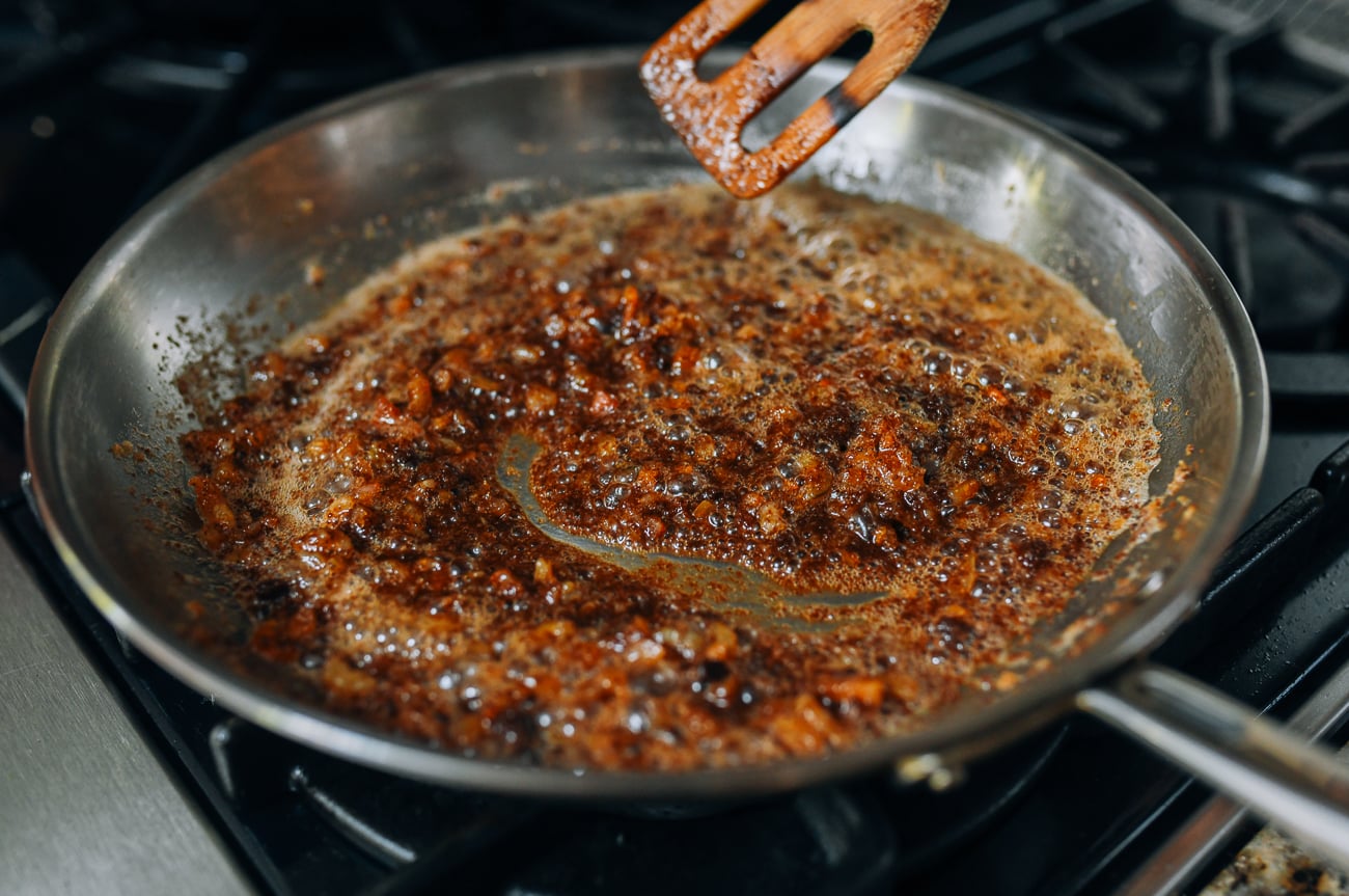 Melting belacan into oil with dried shrimp