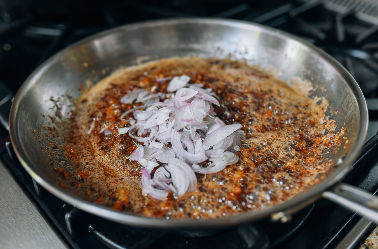 Adding shallots to shrimp sauce