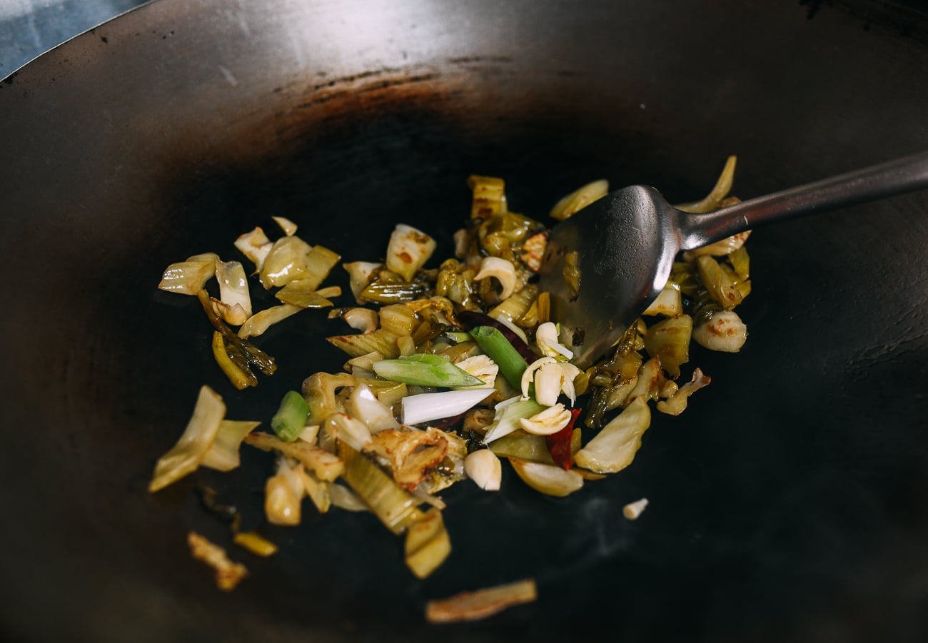 Stir-frying mustard greens with aromatics