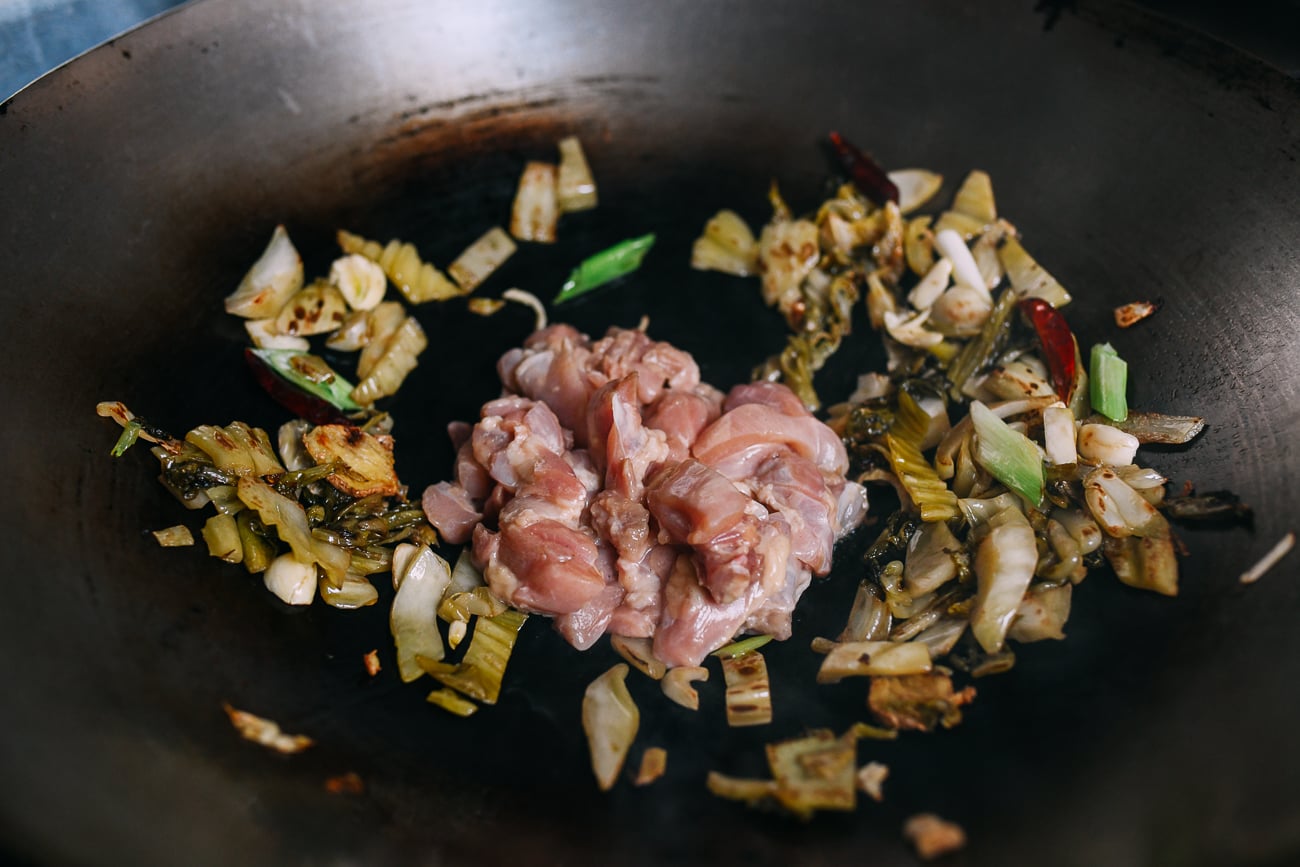 Adding chicken to hot wok