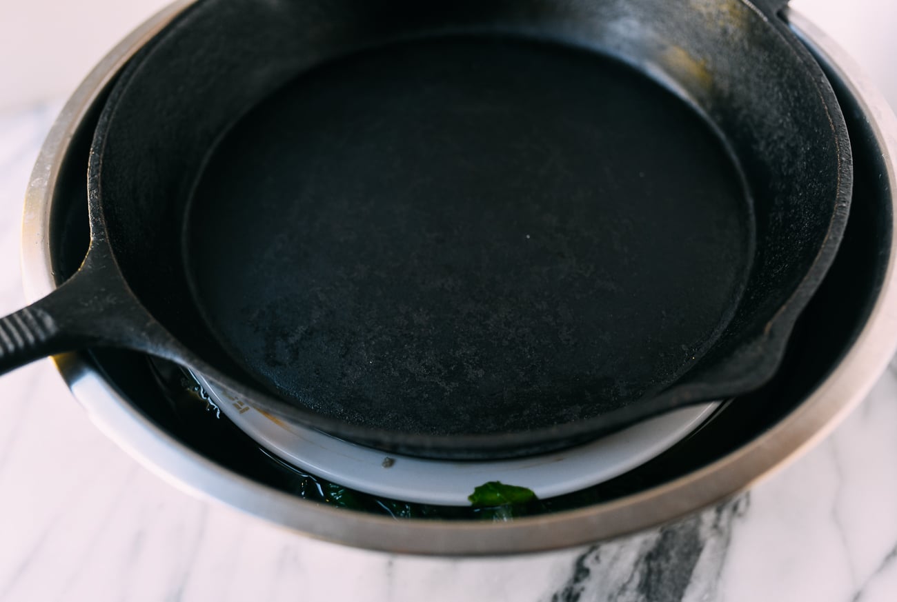 Mustard greens in brine with weight on top