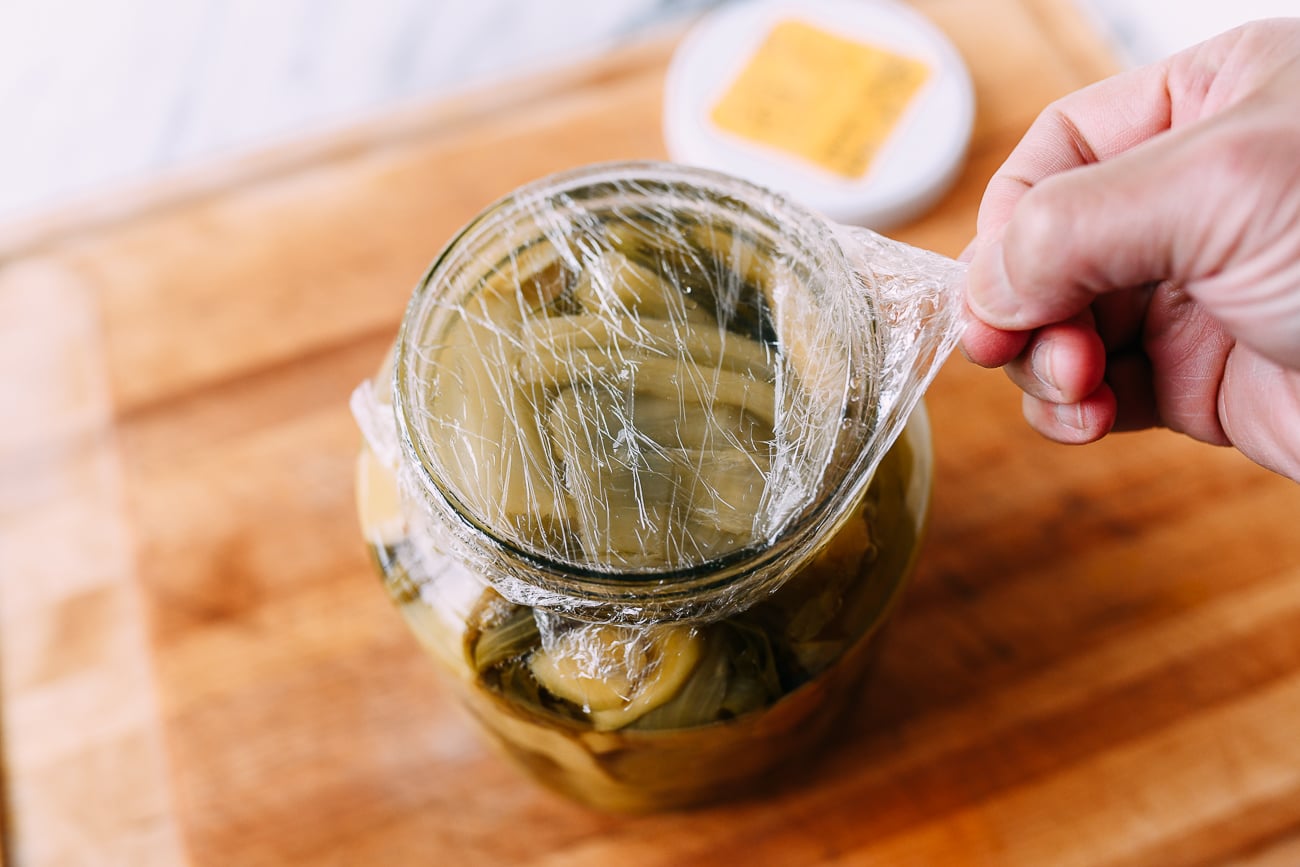 Removing plastic wrap from jar