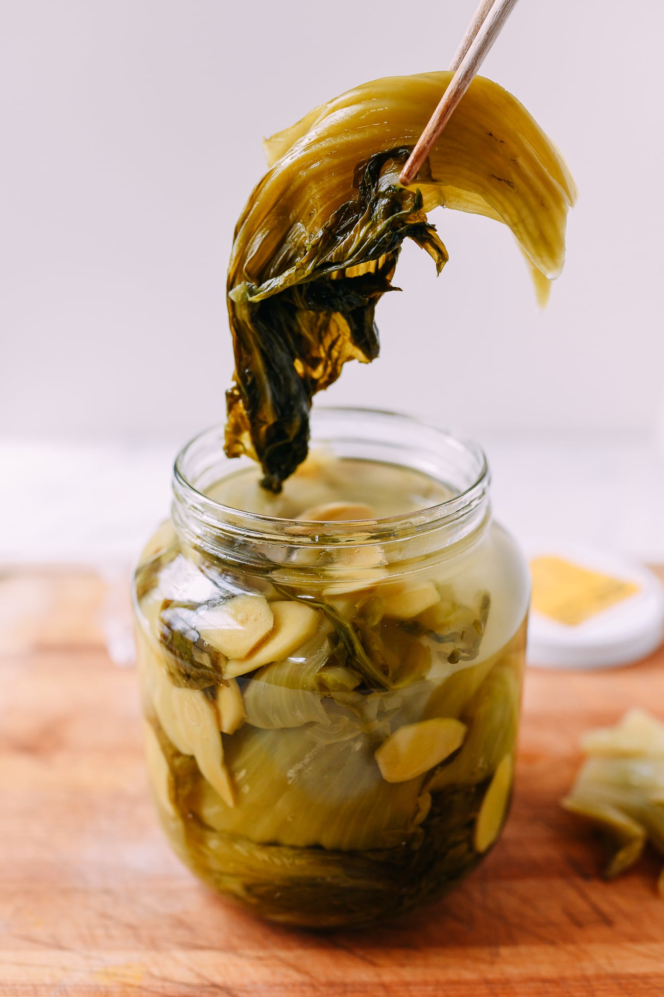 Removing pickled mustard greens from jar